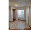 Tiled entryway with coat closet and front door offering natural light through a window at 3536 Countrybrook Ln # 13, Palm Harbor, FL 34684