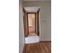 A hallway connects to a view of the spaces, showing a bathroom and bedroom at 3536 Countrybrook Ln # 13, Palm Harbor, FL 34684