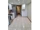 Spacious kitchen showcasing stainless steel appliances, ample storage, and tile flooring at 3536 Countrybrook Ln # 13, Palm Harbor, FL 34684