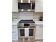 Updated stainless steel oven and microwave and herringbone backsplash at 3536 Countrybrook Ln # 13, Palm Harbor, FL 34684