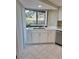 A kitchen sink has white shaker-style cabinetry and stainless steel appliances at 3536 Countrybrook Ln # 13, Palm Harbor, FL 34684