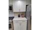 Updated kitchen offering stainless steel appliances, modern backsplash, and white cabinetry at 3536 Countrybrook Ln # 13, Palm Harbor, FL 34684