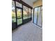 Covered lanai offering tiled floor, sliding glass door, and view of the green backyard at 3536 Countrybrook Ln # 13, Palm Harbor, FL 34684