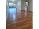 A living room boasts modern wood-look flooring and access to a screened-in porch at 3536 Countrybrook Ln # 13, Palm Harbor, FL 34684