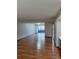 Spacious living room featuring hardwood floors and sliding glass doors to outdoor area at 3536 Countrybrook Ln # 13, Palm Harbor, FL 34684