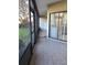 Enclosed patio with tile flooring and view of lawn at 3536 Countrybrook Ln # 13, Palm Harbor, FL 34684