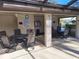 Poolside patio featuring seating arrangement and pool rules under covered area at 3536 Countrybrook Ln # 13, Palm Harbor, FL 34684