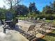Poolside patio featuring tables, chairs, umbrellas, and lounge chairs at 3536 Countrybrook Ln # 13, Palm Harbor, FL 34684