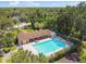 Aerial view of community pool with lounging area and lush green surroundings at 3673 Fremantle Dr, Palm Harbor, FL 34684