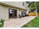 Paver patio with outdoor seating and access to home with dual glass doors at 3673 Fremantle Dr, Palm Harbor, FL 34684