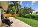 Private outdoor patio with brick pavers, mature landscaping, and a tranquil fenced yard at 3673 Fremantle Dr, Palm Harbor, FL 34684