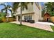 Large backyard with seating area, paver patio, and a charming playhouse at 3673 Fremantle Dr, Palm Harbor, FL 34684