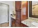 Bathroom with dark wood cabinets, granite countertops, and tiled floors at 3673 Fremantle Dr, Palm Harbor, FL 34684