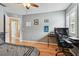 This bedroom includes hardwood floors, neutral paint, and is furnished with a modern black desk at 3673 Fremantle Dr, Palm Harbor, FL 34684