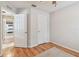 Bedroom with laminate floors, white trim, and views into another room at 3673 Fremantle Dr, Palm Harbor, FL 34684