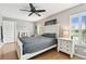 Bright bedroom featuring a wooden bed frame, hardwood floors, and a ceiling fan at 3673 Fremantle Dr, Palm Harbor, FL 34684