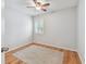 Bedroom with laminate flooring, fan, and window with plantation shutters at 3673 Fremantle Dr, Palm Harbor, FL 34684