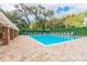 Large community swimming pool area with ample lounge chairs and manicured landscaping at 3673 Fremantle Dr, Palm Harbor, FL 34684