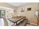 Dining area with wood table, chairs, and a bench; bathed in natural light at 3673 Fremantle Dr, Palm Harbor, FL 34684