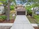 Charming two-story home with a well-manicured lawn, brown two-car garage and mature trees in a desirable community at 3673 Fremantle Dr, Palm Harbor, FL 34684