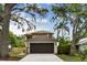 Charming two-story home features a two-car garage, manicured landscaping and mature trees at 3673 Fremantle Dr, Palm Harbor, FL 34684