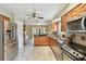 Modern kitchen with stainless steel refrigerator, wood floors, and matching cabinets at 3673 Fremantle Dr, Palm Harbor, FL 34684