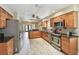 Spacious kitchen with stainless steel appliances and wood cabinets offers modern appeal at 3673 Fremantle Dr, Palm Harbor, FL 34684