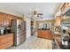 Well-lit kitchen features stainless steel fridge, granite counters, and sleek appliances at 3673 Fremantle Dr, Palm Harbor, FL 34684