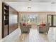 Bright living room with built-ins, shuttered windows, and modern decor, creating a stylish space at 3673 Fremantle Dr, Palm Harbor, FL 34684