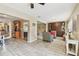 Open-concept living area with wood-look floors, leading to the kitchen and second living space at 3673 Fremantle Dr, Palm Harbor, FL 34684