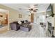 Inviting living room featuring a fireplace, wood-look floors, and modern ceiling fan at 3673 Fremantle Dr, Palm Harbor, FL 34684