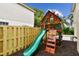 Backyard play structure with a slide, climbing area, and wood mulch at 3673 Fremantle Dr, Palm Harbor, FL 34684