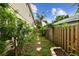 Narrow side yard featuring a stone pathway and wooden fence boundary at 3673 Fremantle Dr, Palm Harbor, FL 34684