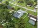 Overhead shot of a home with screen enclosed pool, sheds, privacy fence, and a well manicured lot at 37331 Hickory Hill Ln, Dade City, FL 33525