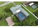 Aerial view of a beautiful home featuring an in-ground pool, fenced yard, and mature landscaping at 37331 Hickory Hill Ln, Dade City, FL 33525