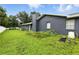 The property features a spacious backyard with a house and lush green lawn at 37331 Hickory Hill Ln, Dade City, FL 33525