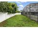 Lush backyard featuring privacy fence, green lawn, and screened-in pool area, great for outdoor activities at 37331 Hickory Hill Ln, Dade City, FL 33525