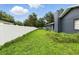 Backyard features a green lawn and a white fence at 37331 Hickory Hill Ln, Dade City, FL 33525