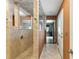 Walk-in shower, hallway and bathroom entrance area with modern fixtures and neutral tiling at 37331 Hickory Hill Ln, Dade City, FL 33525