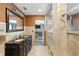 View of bathroom with double vanity with framed mirror and step-in shower with tiled surround at 37331 Hickory Hill Ln, Dade City, FL 33525