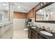 A spacious bathroom boasts a double vanity, tiled floors, and a walk-in shower with glass doors at 37331 Hickory Hill Ln, Dade City, FL 33525