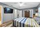 Cozy bedroom featuring a ceiling fan, TV, wood floors, and ample closet space at 37331 Hickory Hill Ln, Dade City, FL 33525