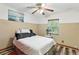 Cozy bedroom with wood-look floors, ceiling fan, and a window providing natural light at 37331 Hickory Hill Ln, Dade City, FL 33525