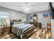 Bedroom with gray walls, wood-look floors, ceiling fan, and antique-style furniture at 37331 Hickory Hill Ln, Dade City, FL 33525