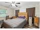 Bedroom with wood look floors, ceiling fan, and natural light from the window at 37331 Hickory Hill Ln, Dade City, FL 33525