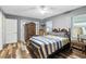 Bedroom featuring gray walls, wood-look floors, ceiling fan, antique-style dresser at 37331 Hickory Hill Ln, Dade City, FL 33525