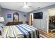 This bedroom features a dresser, ceiling fan, TV, wood floors, and closet space at 37331 Hickory Hill Ln, Dade City, FL 33525