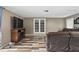 Bonus room with wood-look floors, a sectional couch, dart board, and modern media center at 37331 Hickory Hill Ln, Dade City, FL 33525