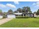 Charming single-story home featuring a well-manicured lawn, attached garage, and a welcoming entrance at 37331 Hickory Hill Ln, Dade City, FL 33525