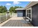 View of the front porch, showcasing its tiled flooring, outdoor seating, and white picket fence at 37331 Hickory Hill Ln, Dade City, FL 33525